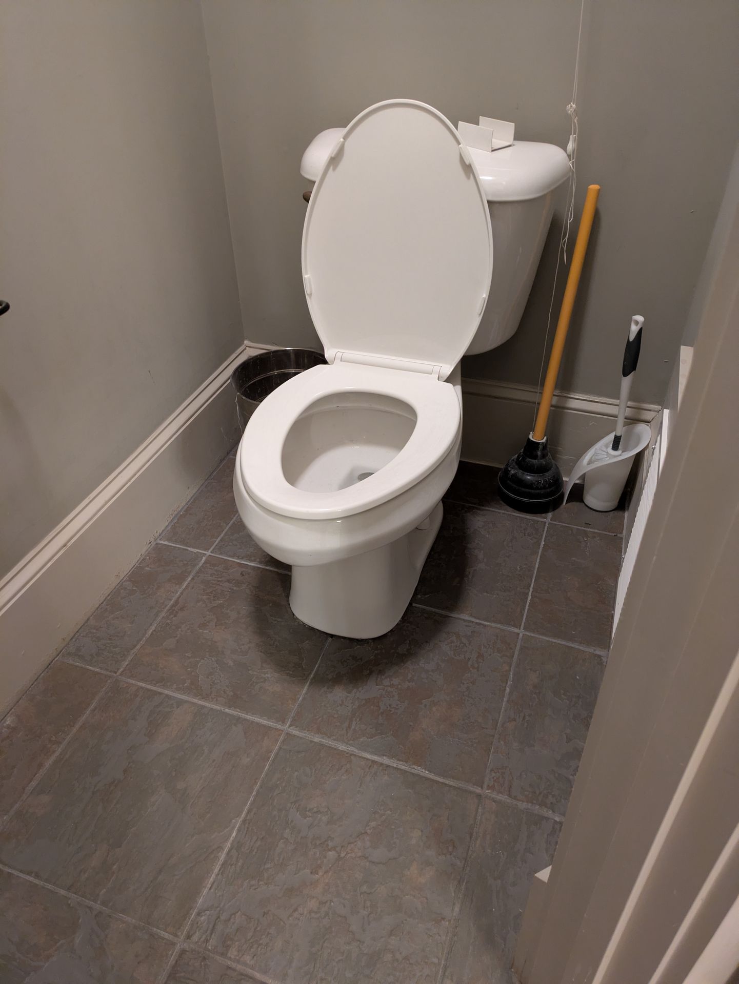 New modern toilet and tile floor in a Normaltown bathroom renovation